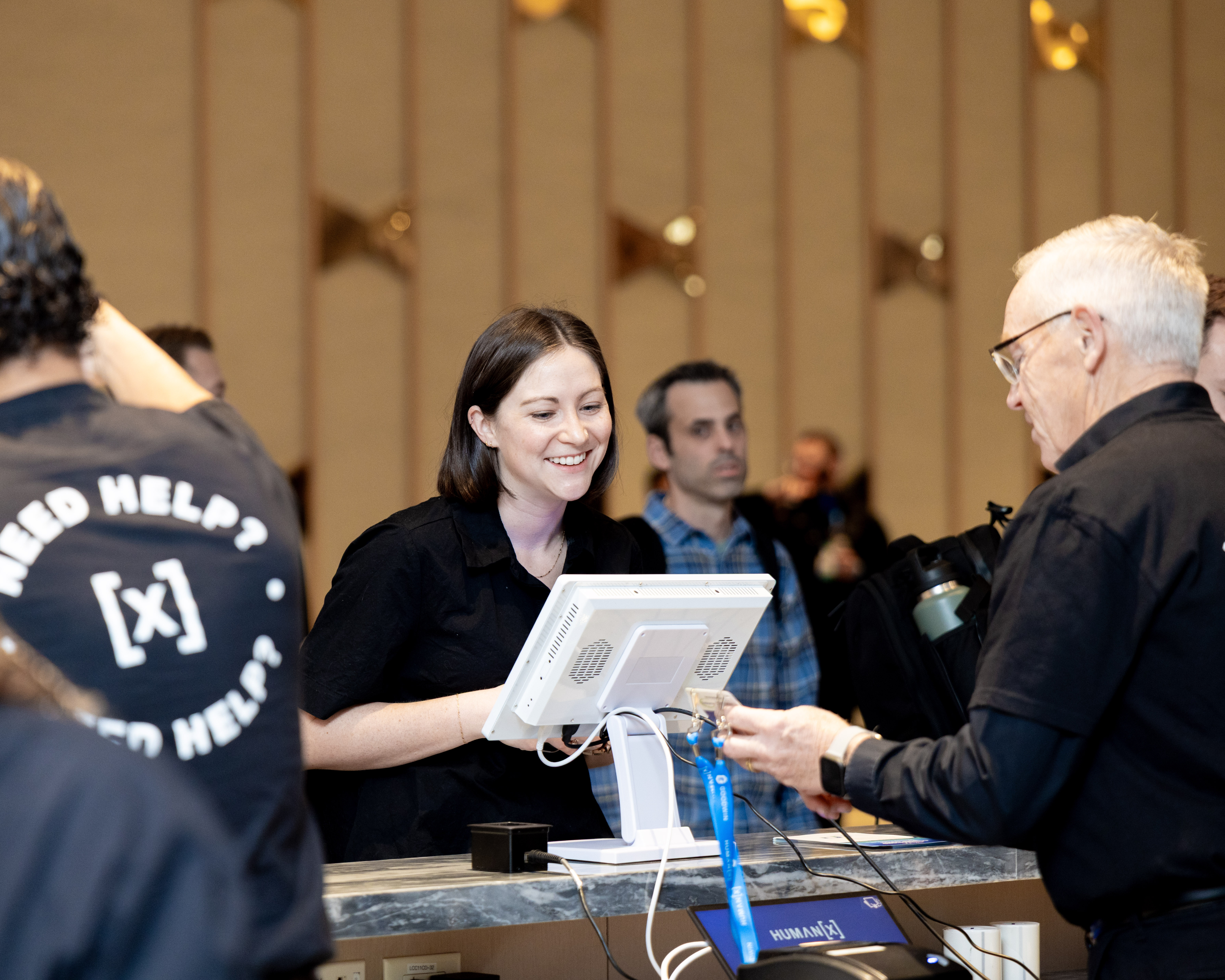 a smiling visitor checks in at humanx 2025