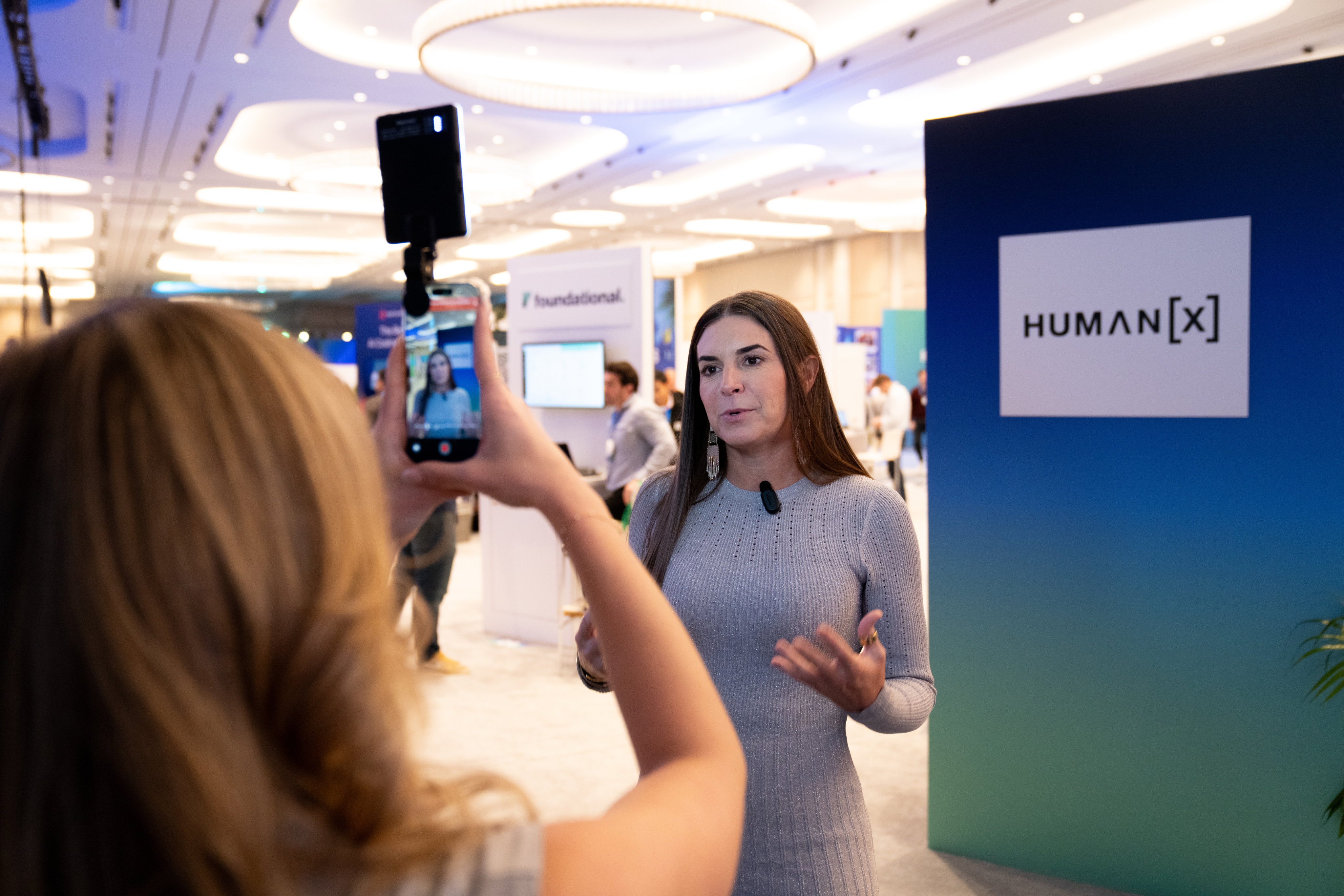 a journalist records another journalist on the show floor at humanx 2025