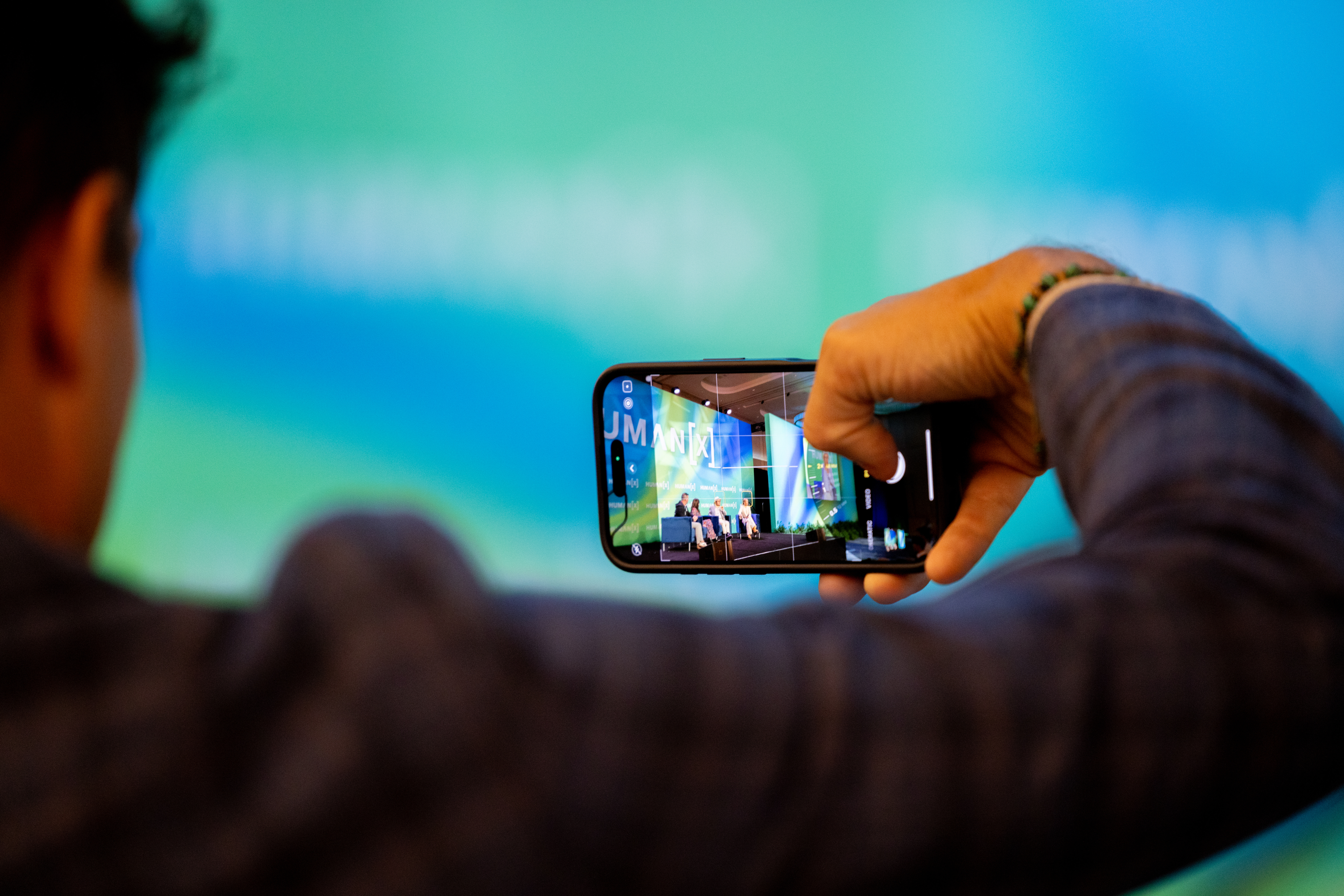 a man is recoding a stage session at humanx 2025